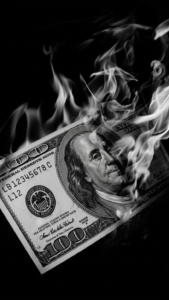 A powerful money background aesthetic showing a burning dollar bill with a dark luxury vibe. This wallpaper backgrounds idea represents transformation, ambition, and creating a new level of success.